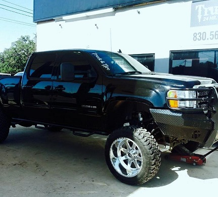 Lifted pickup truck with custom wheels